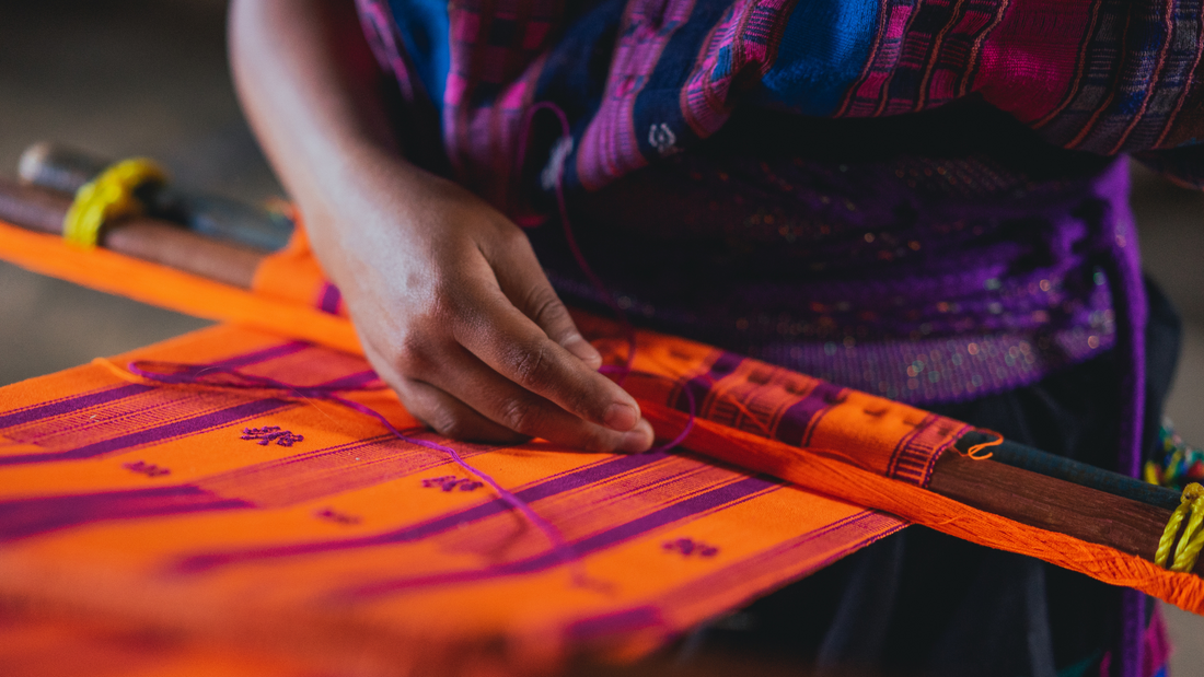 Indigenous Mayan artisan skillfully weaving traditional embroidery for a dog collar, showcasing authentic cultural techniques.