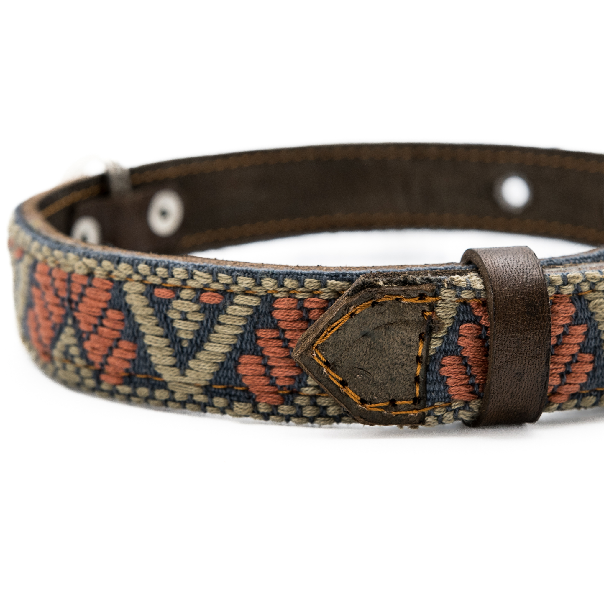 Close-up of a leather loop on a Bronze Olive dog collar, highlighting the meticulous workmanship.