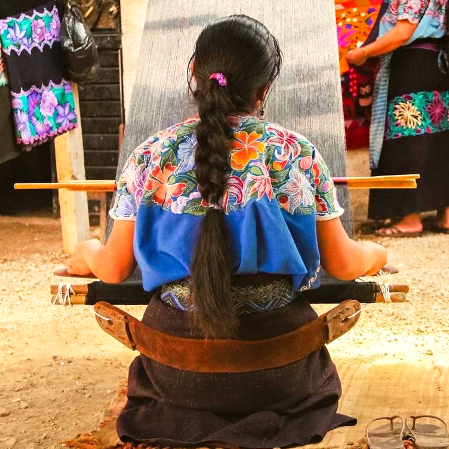 **Image of an indigenous woman from southern Mexico weaving the intricate embroidery of a handmade leather dog collar using ancient Aztec techniques.**