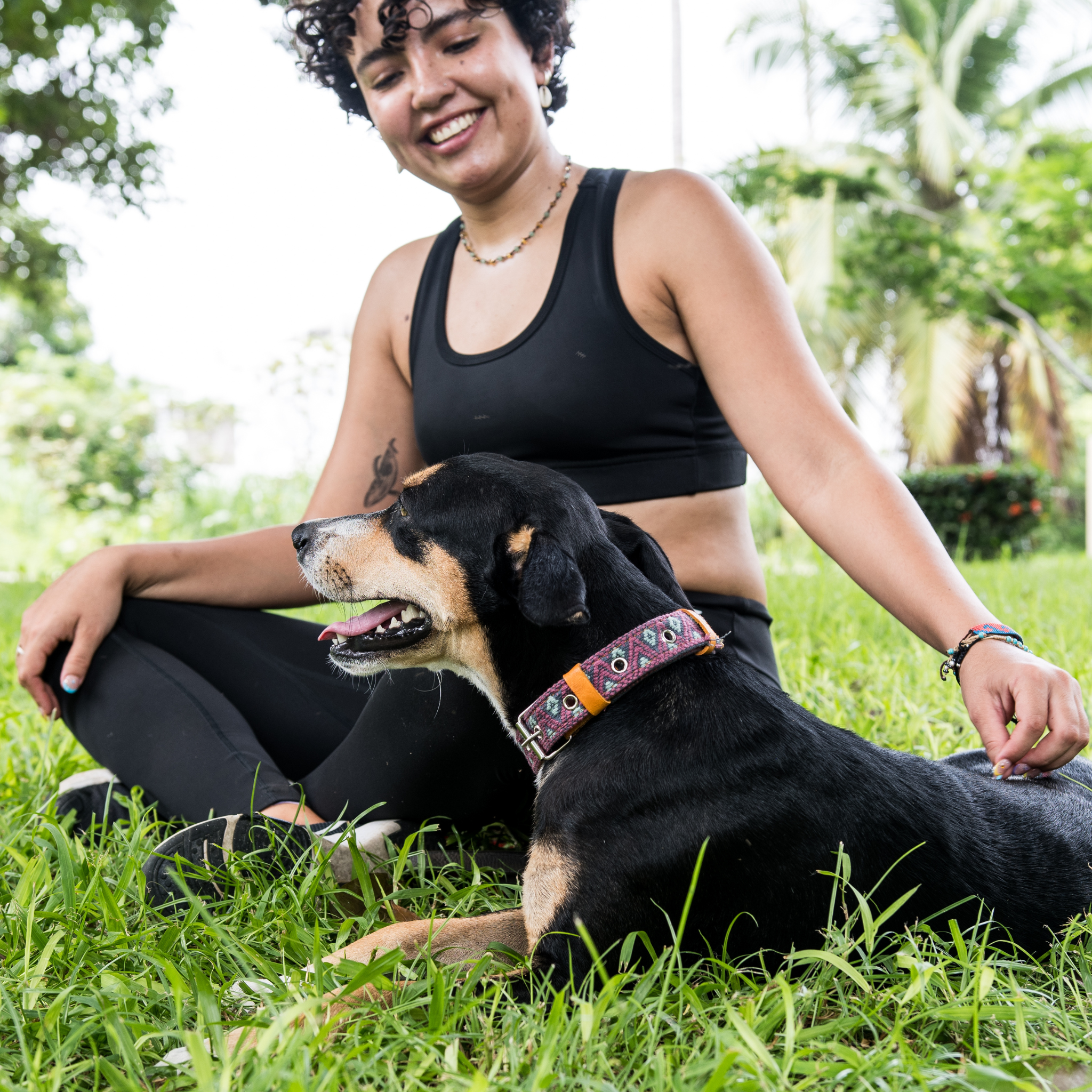 A dog with its owner, both appearing happy and content, with the dog wearing a Camelot collar.